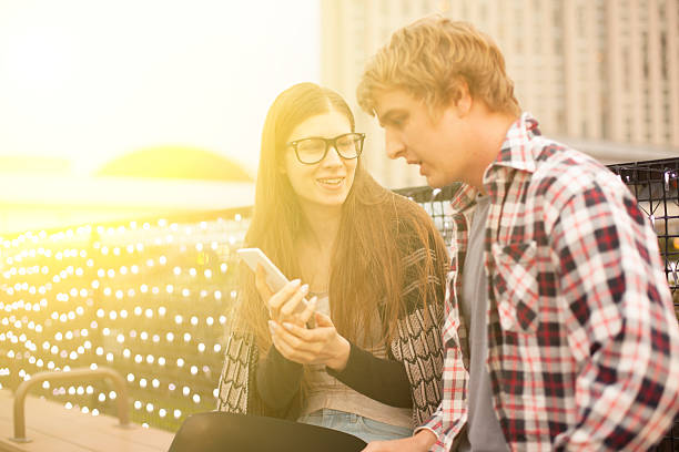 istock Young couple looking at mobile phone 476950022