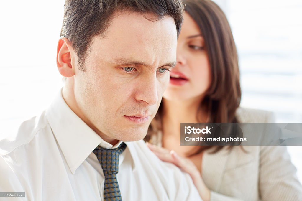 Relieving stress Tired businessman receiving shoulder massage from hi secretary Sexual Harassment Stock Photo