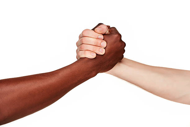 istock Black and white human hands in a modern handshake 476953122