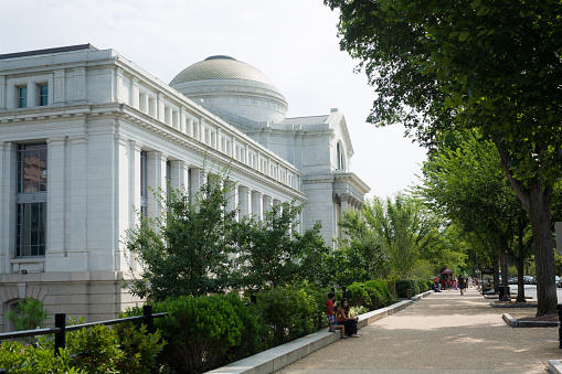 Washington, United States - August 18, 2014: People mill about the pathway outside the Smithsonian National Museum of Natural History along the National Mall. With free admission and open doors 364 days a year, it is the second most visited museum in the world, the most visited natural history museum in the world, and the most visited museum (of any type) in North America.