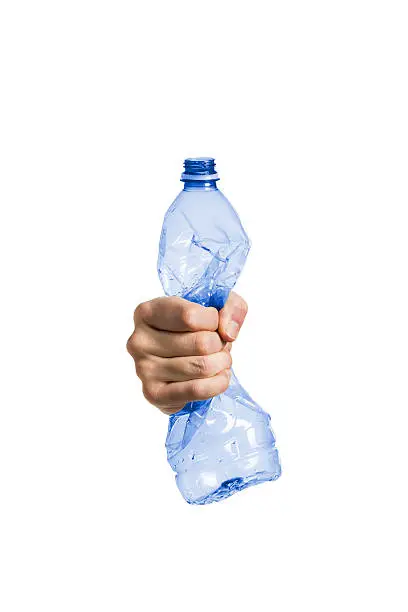 Plastic and pet recycling- studio shot of a squeezed plastic bottle isolated on white background