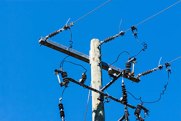 istock Old wood telephone pole with metal bar and insulators 476954908