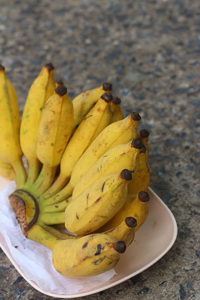 istock Bananas place on a pink plate on cement 476954928