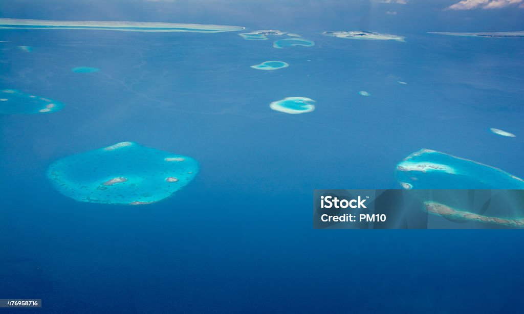 Aerial view of uninhabited islands and coral reefs in Maldives Aerial view of uninhabited islands, crystal clear waters and coral reefs in Maldives 2015 Stock Photo