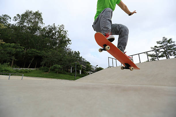 istock skateboarder doing ollie at sunrise skatepark 476959326