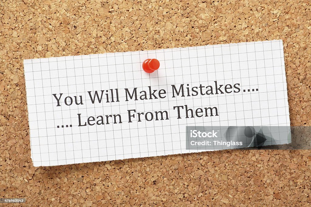Learn From Mistakes The phrase You Will Make Mistakes, Learn From Them typed on a piece of graph paper and pinned to a cork notice board. A way of empowering people on their road to success. Graph Paper Stock Photo