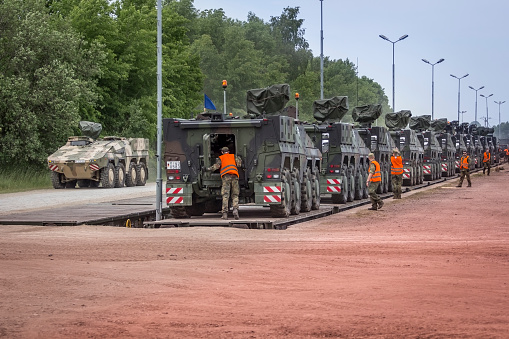 Drawsko Pomorskie, Poland - June 06, 2015:German soldiers unload military equipment on a railway siding. They are preparing for the maneuvers codenamed „Saber Strike-15” on the military training area in Drawsko Pomorskie, Poland. 