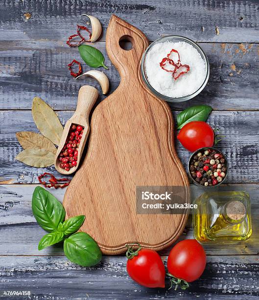 Spices Olive Oil Tomatoes And Wooden Board Stock Photo - Download Image Now - 2015, Backgrounds, Basil