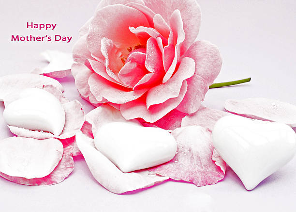 Happy Mothers Day Card with bright red rose, rose petals and white porcelain hearts