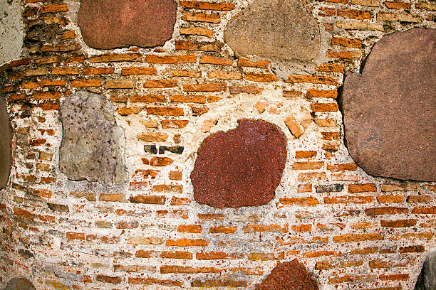 Historic Spanish colonial architecture in Intramuros, Manila, featuring a stone edifice, barred windows, and a traditional lamppost, hinting at layers of history and urban life.