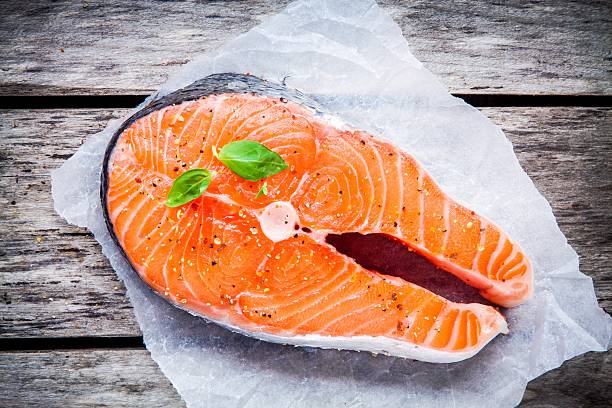 istock fresh raw salmon steak on paper with basil 476968122