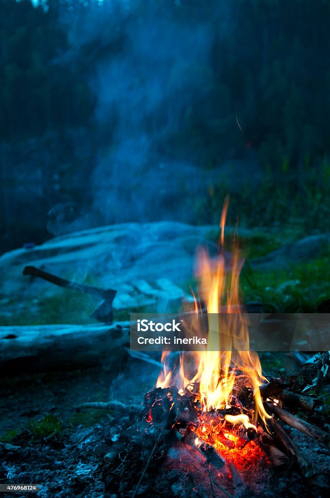 camp fire Camp fire on the river bank, vertical 2015 Stock Photo