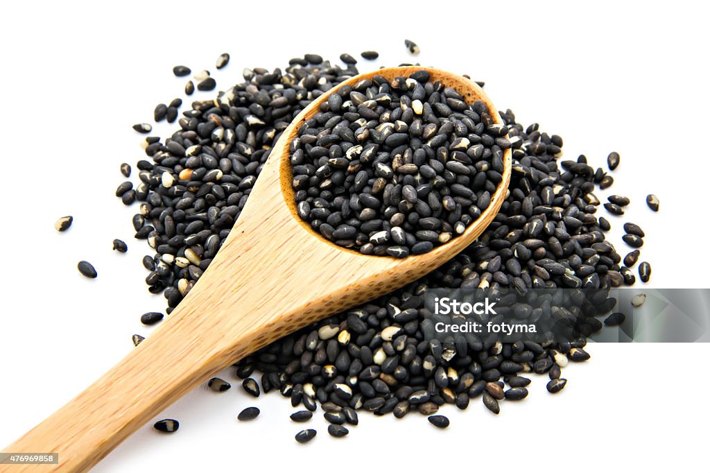 black sesame pile of black sesame on wooden spoon 2015 Stock Photo