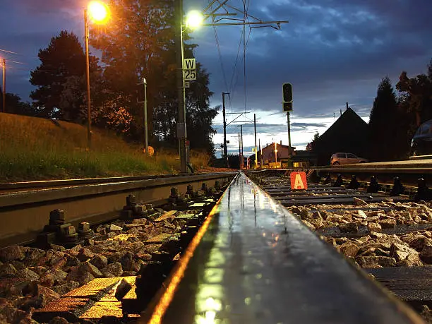 Tram-line on the Swiss-French border, part of the wider Basel tram system, taken at night after a heavy rainfall.