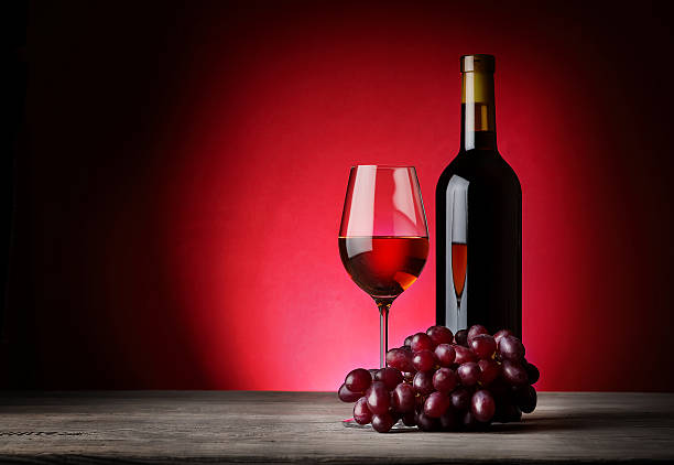 istock Bottle and glass of wine with grapes 476972274