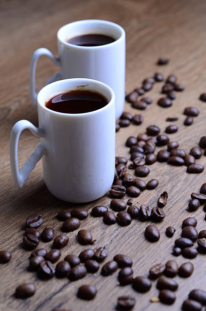 istock Two cups of expresso surrounded by coffee beans 476972430