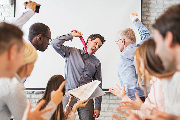 Stressful day in the office! Large group of business people blaming their colleague who finds them very annoying. woman strangles man stock pictures, royalty-free photos & images
