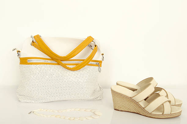 istock White and yellow purse with matching wedge sandals. 476975686