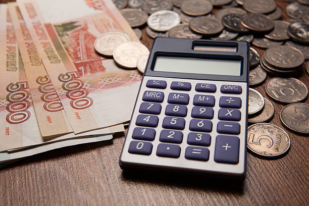 istock handful of Russian rubles with calculator 476976318