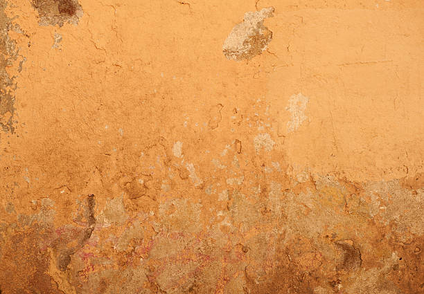 istock Texture of old wall covered with brown stucco 476977410