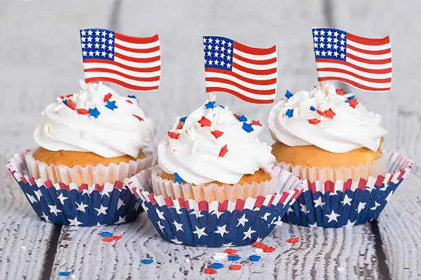 Photo of Patriotic cupcakes with sprinkles and American flags