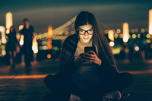 Young nerd woman texting on the phone