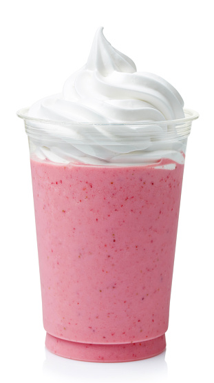 Strawberry milkshake covered with whipped cream in plastic glass isolated on white background