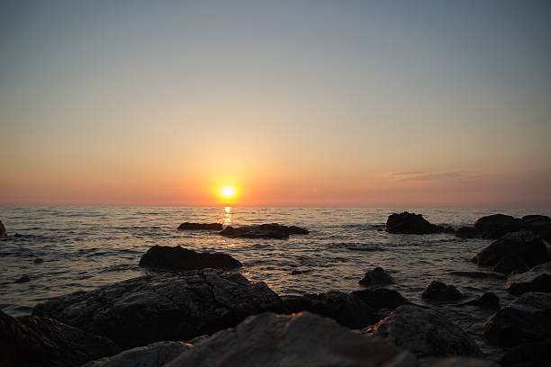 istock Sunset over the sea among the rocks 476983330