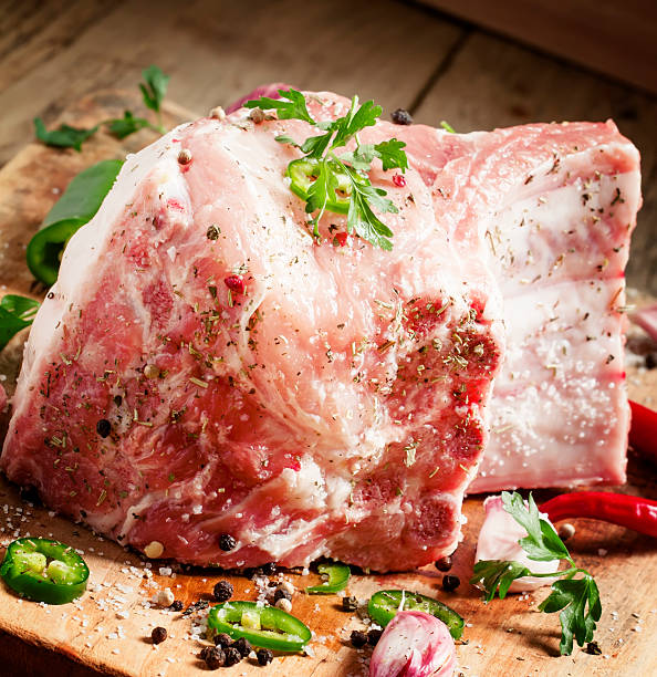 Fresh whole pork loin with spices, selective focus
