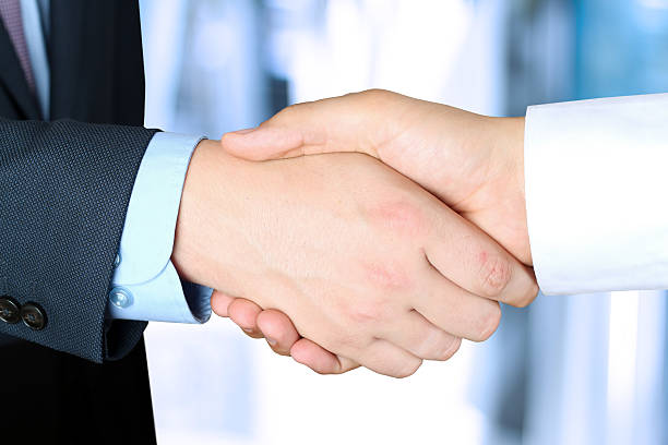 istock Image of a firm handshake  between two colleagues in office 476983900