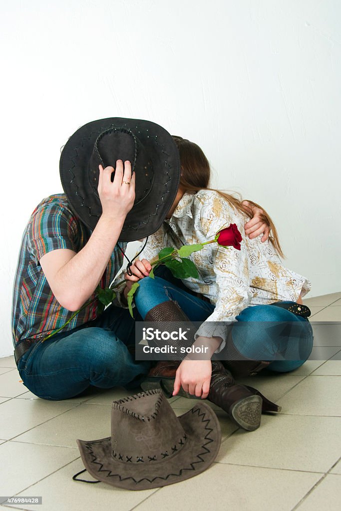 Cowboy's love story The guy and the girl in cowboy's suits on a white background 2015 Stock Photo