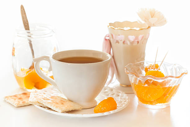 cup of tea and tangerine slice stock photo