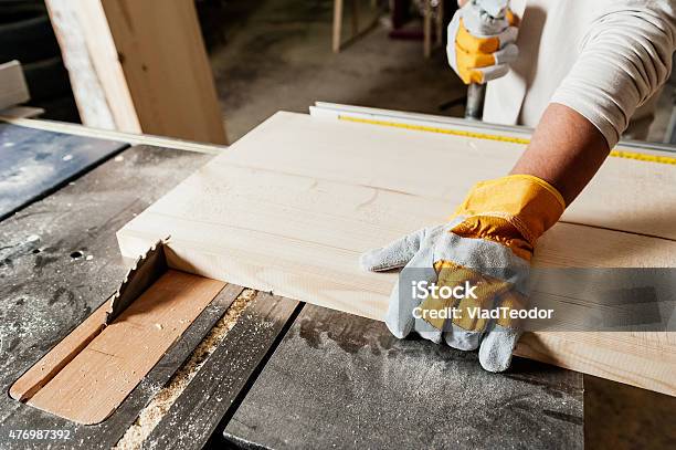 Close Up Of Carpenter Working On Machine Stock Photo - Download Image Now - 2015, Adult, Adults Only