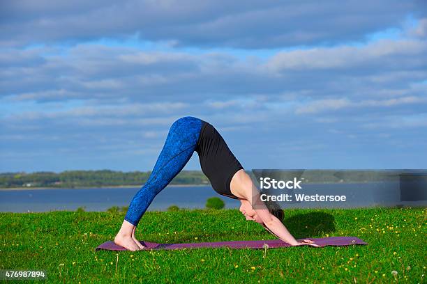 Young Woman Doing Yoga Near Cost Stock Photo - Download Image Now - 20-29 Years, 2015, Active Lifestyle