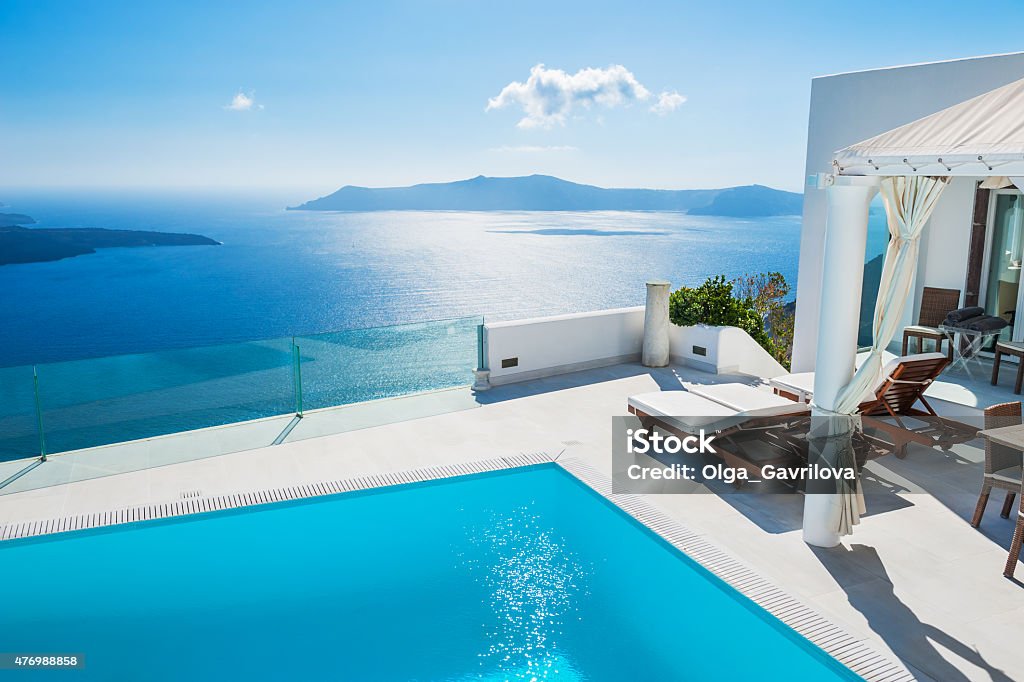White architecture on Santorini island, Greece. White architecture on Santorini island, Greece. Swimming pool in luxury hotel. Beautiful landscape with sea view Hotel Stock Photo