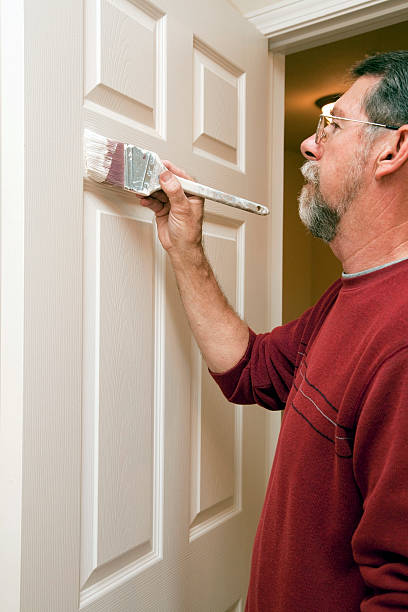 istock Painter painting trim around doors & windows 476992716
