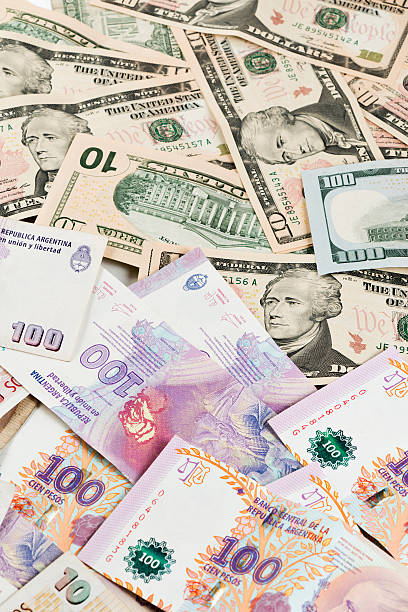 istock US Dollar and Argentine Peso Banknotes 476993212