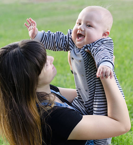 istock young mother playing with baby 476993840