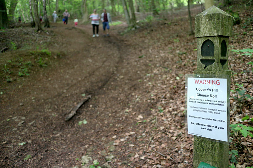 Warning sign to spectators and participants, regarding the world famous Cheese Rolling event held annually on Cooper’s Hill in Gloucestershire