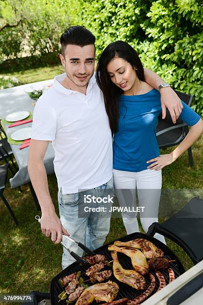 Cheerful Couple Man Woman Cooking Barbecue Outdoor Summer Garden Party Stock Photo - Download Image Now