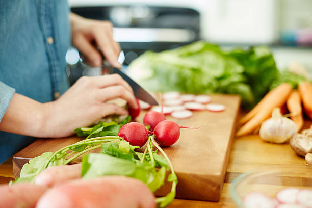 istock Woman chopping red radish on cutting board 476999896