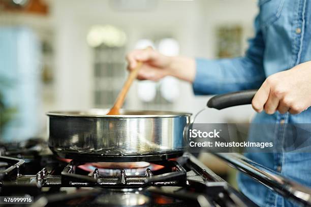 Closeup Of Woman Cooking Food In Frying Pan Stock Photo - Download Image Now - Gas Stove Burner, Cooking, Domestic Life
