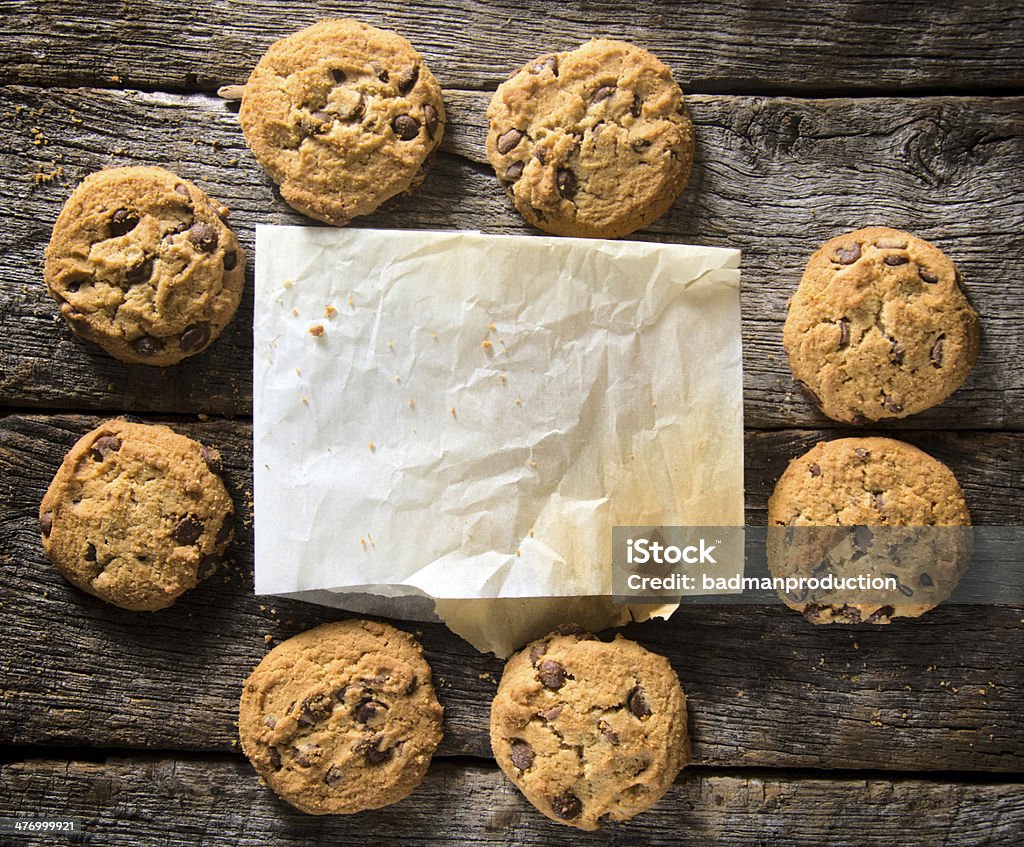 Blank paper and cookies Blank paper and homemade chip cookies on the wooden table Chocolate Stock Photo