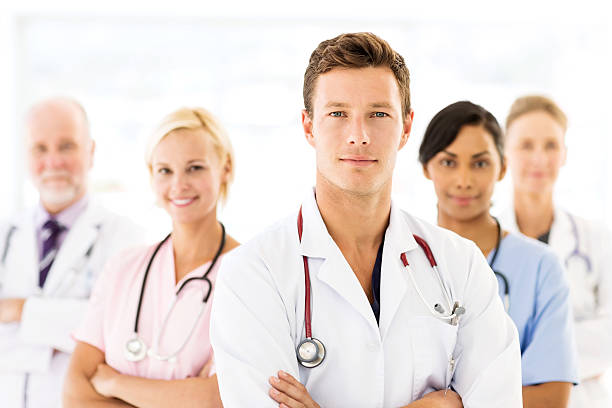 istock Confident Young Doctor With Medical Team 477000200