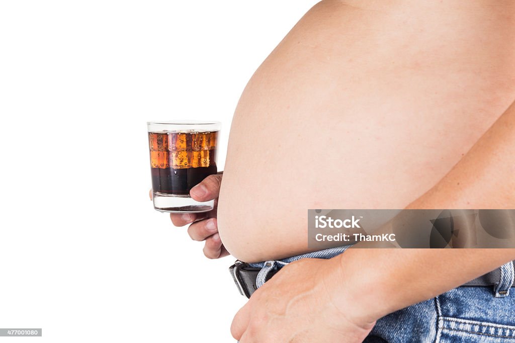 Man with big belly holding a glass of fizzy soda 2015 Stock Photo