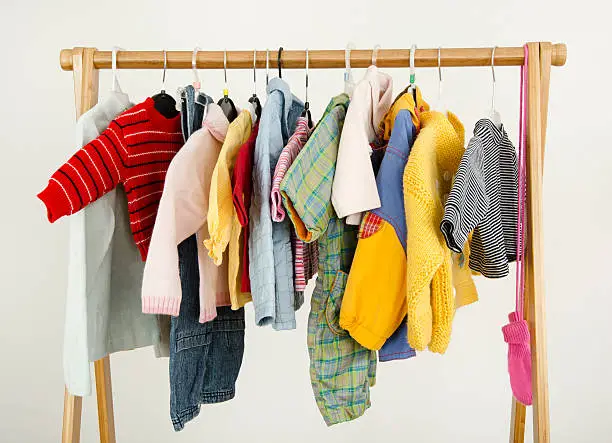 Colorful wardrobe of newborn,kids, babies full of all clothes, accessories.