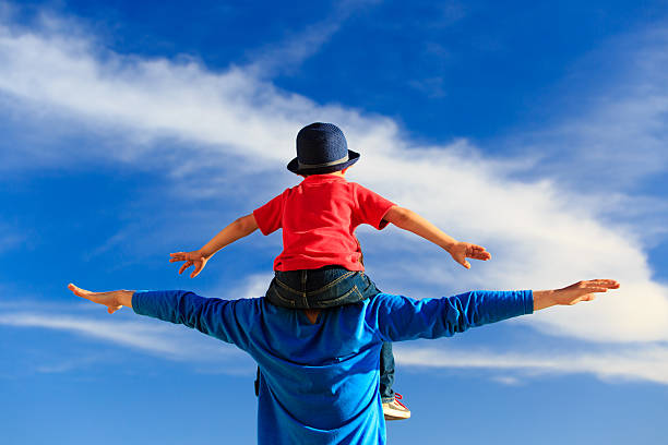 istock father and little son play on sky 477006522