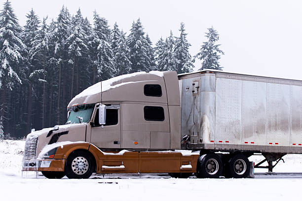 istock Two color modern semi truck and trailer in winter wether 477009931