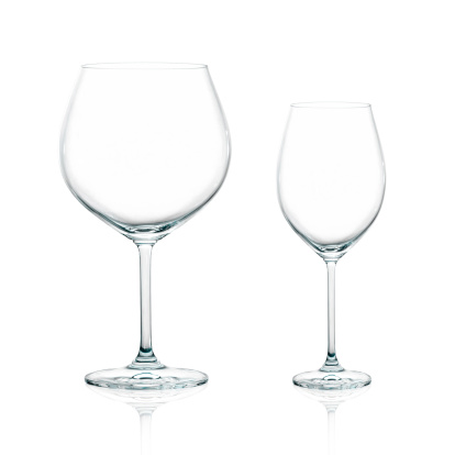 Closeup of two empty cups for wine. Balloon glass for red wine and cup of white wine isolated