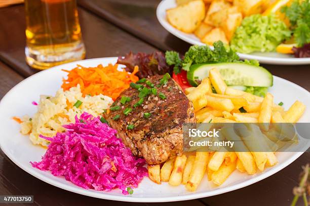 Plate Of Meat Steak With Garnish Stock Photo - Download Image Now - 2015, Barbecue - Meal, Barbecue Grill